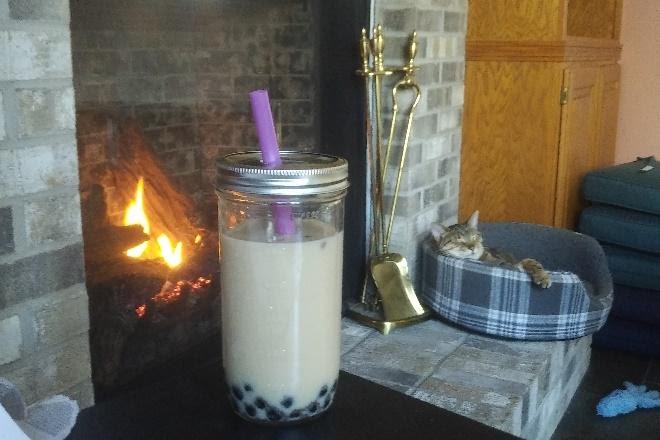 bubble tea in front of a fire place