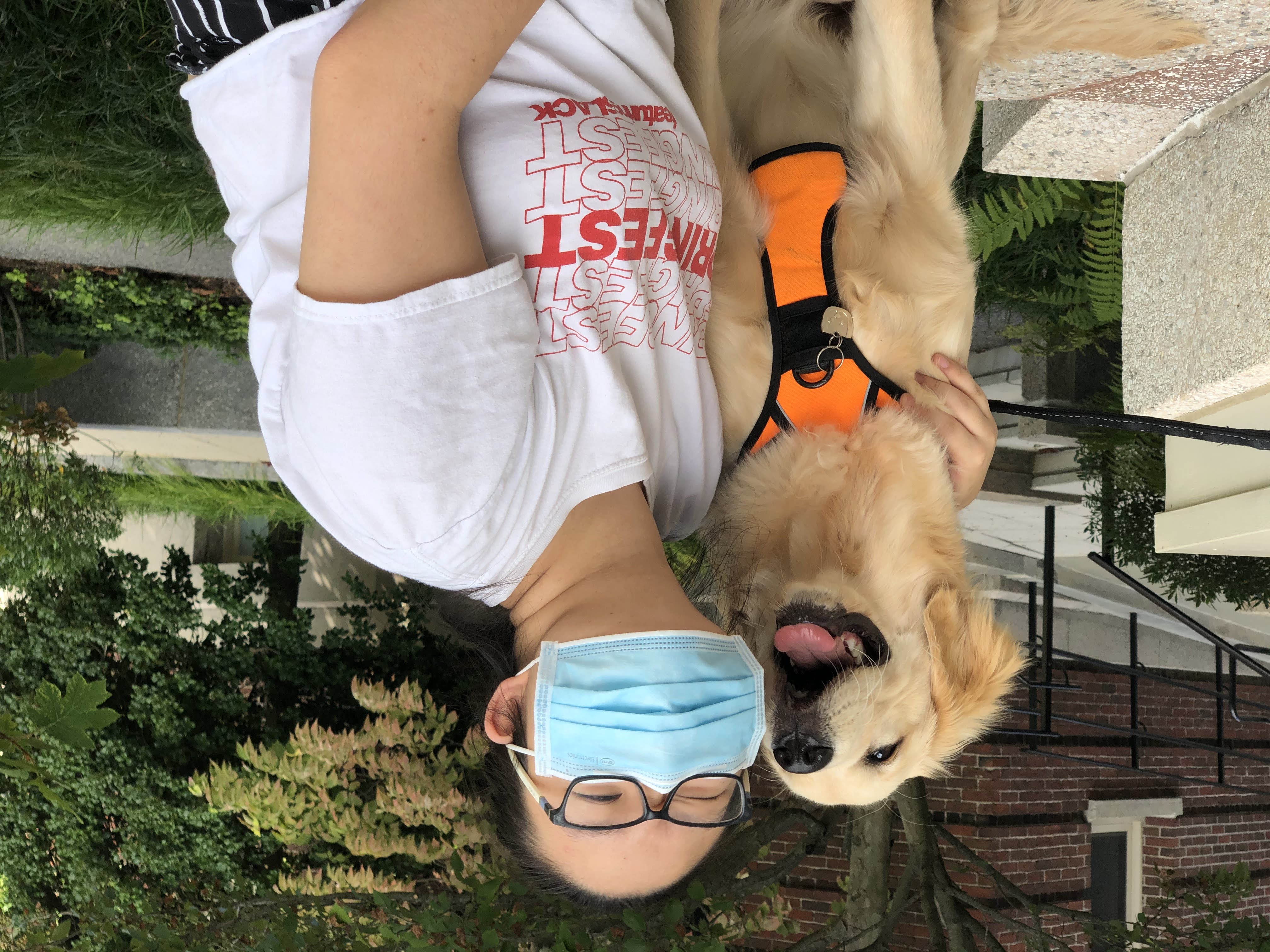 girl with mask on with a dog