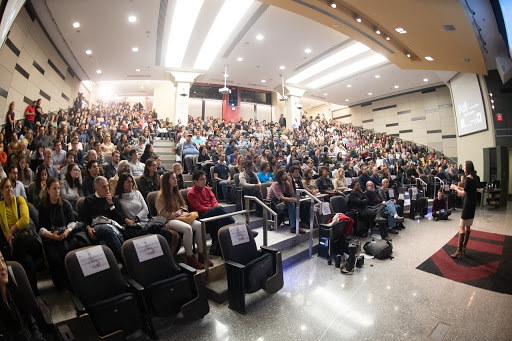 speaker in front of filled auditorium