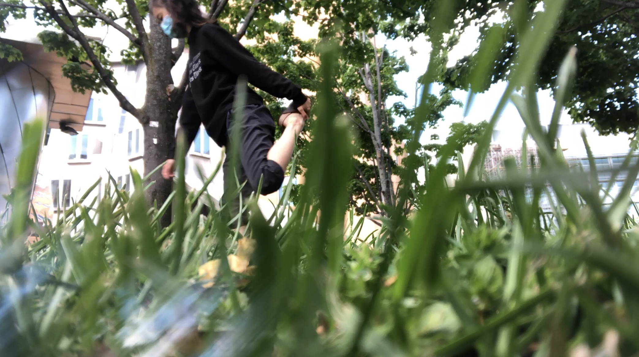 woman stretching viewed through grass