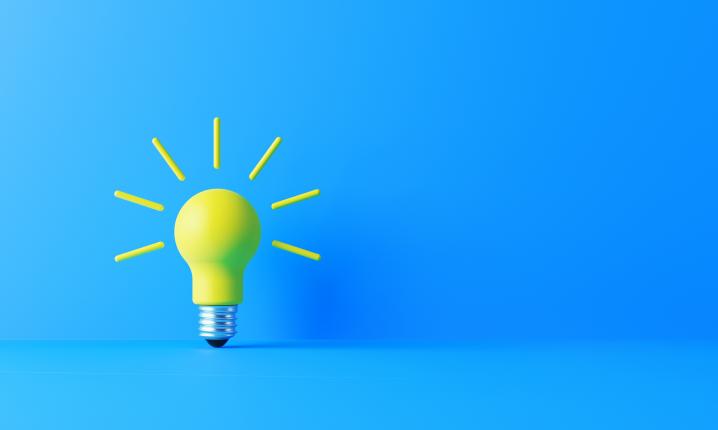 a yellow light bulb with a blue background